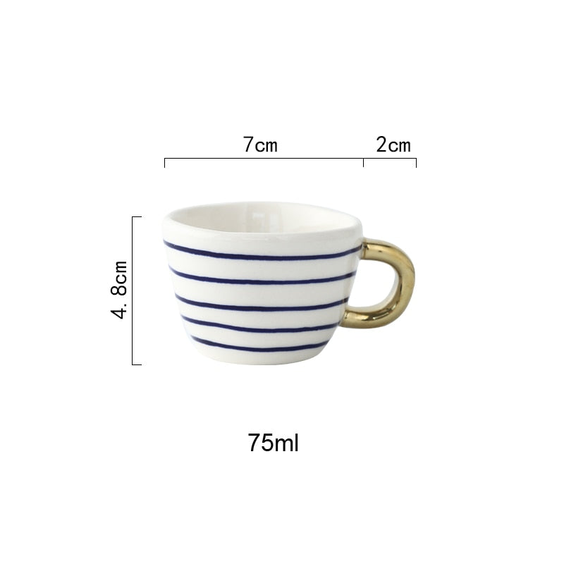 Junips | Cup with abstract geometric pattern and gold handle