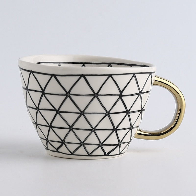 Junips | Cup with abstract geometric pattern and gold handle