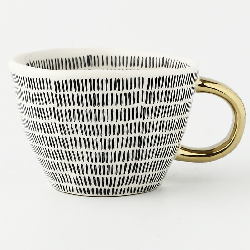 Junips | Cup with abstract geometric pattern and gold handle
