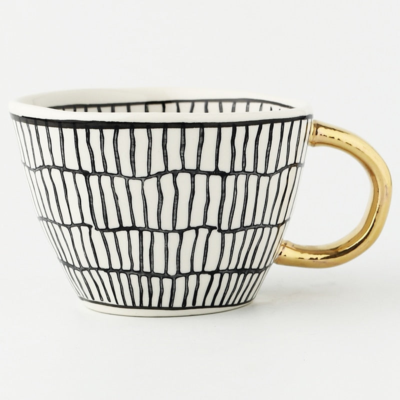 Junips | Cup with abstract geometric pattern and gold handle