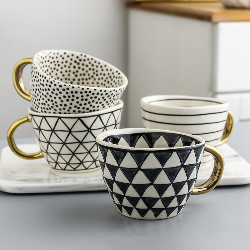 Junips | Cup with abstract geometric pattern and gold handle