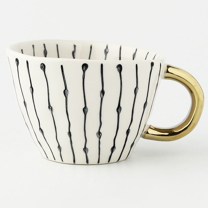 Junips | Cup with abstract geometric pattern and gold handle
