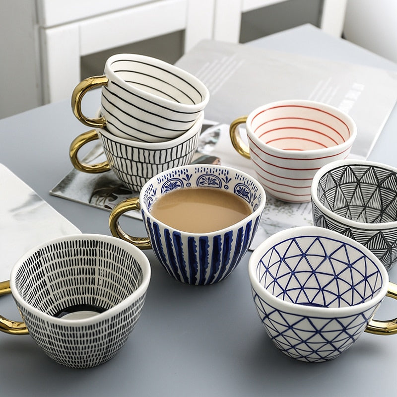 Junips | Cup with abstract geometric pattern and gold handle