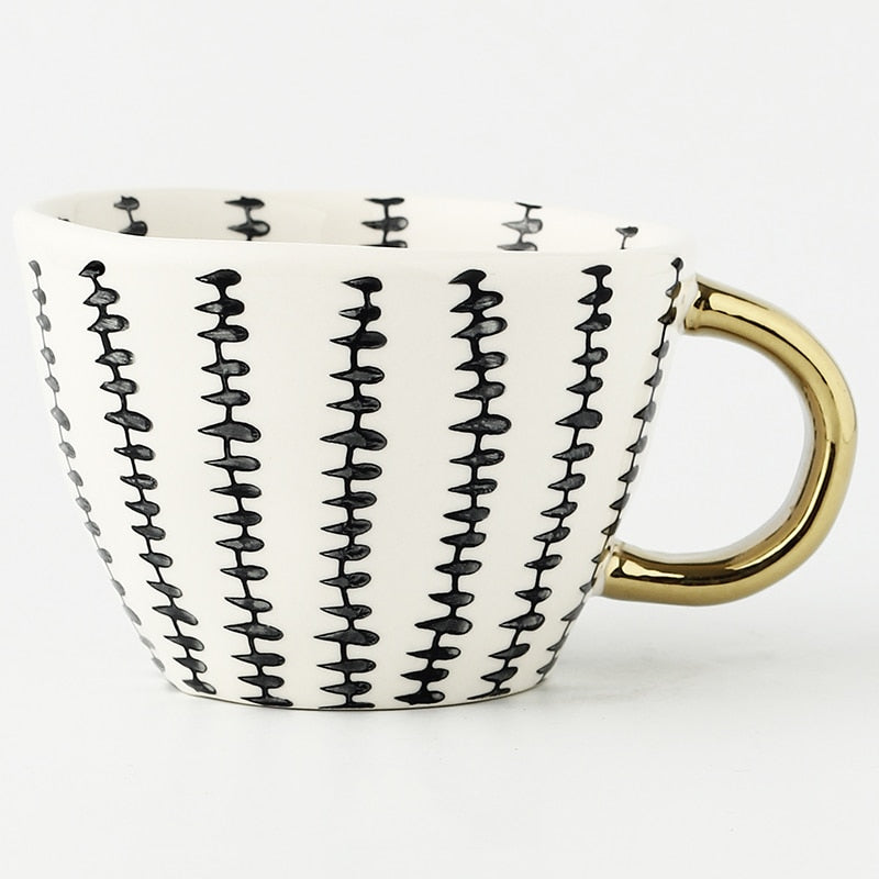 Junips | Cup with abstract geometric pattern and gold handle