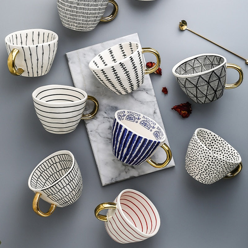 Junips | Cup with abstract geometric pattern and gold handle