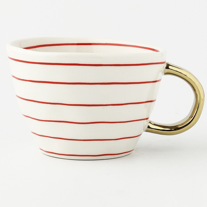 Junips | Cup with abstract geometric pattern and gold handle