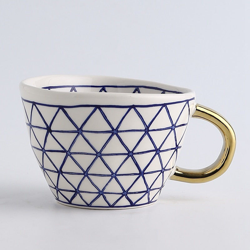 Junips | Cup with abstract geometric pattern and gold handle