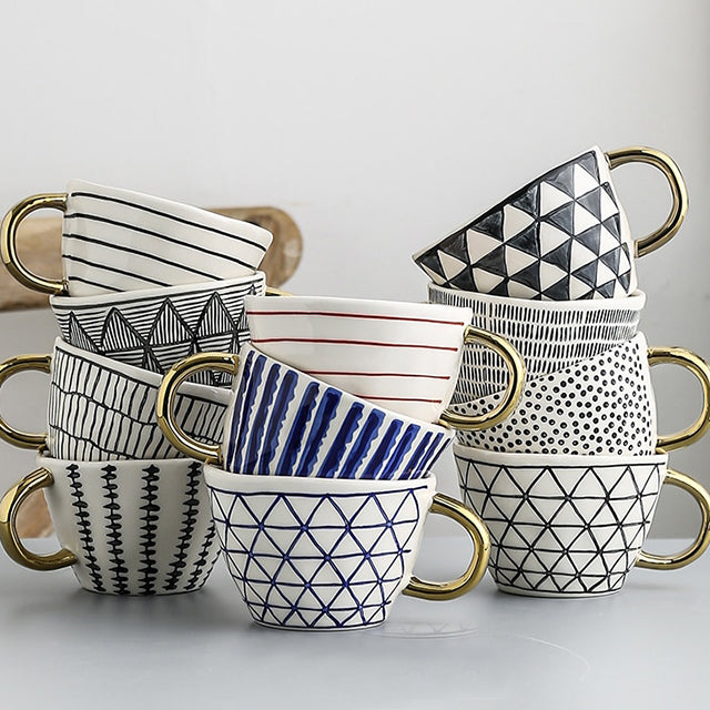 Junips | Cup with abstract geometric pattern and gold handle